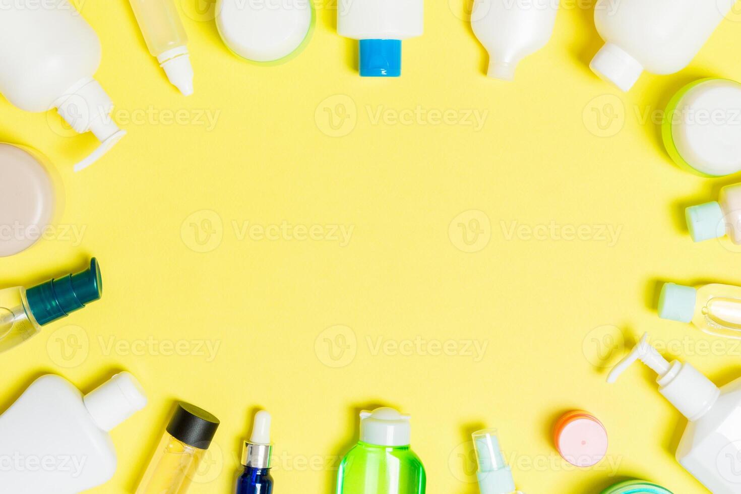 Frame of plastic bodycare bottle Flat lay composition with cosmetic products on yellow background empty space for you design. Set of White Cosmetic containers, top view with copy space photo