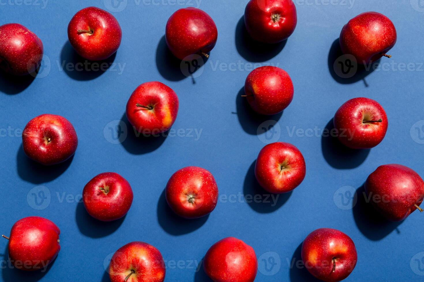 Many red apples on colored background, top view. Autumn pattern with fresh apple above view photo