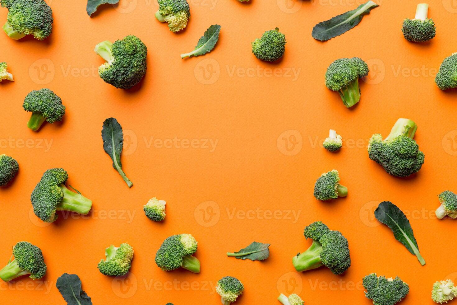 Flat lay composition with fresh green broccoli frame eith copy space on light background photo