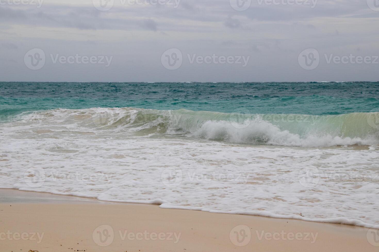 Waves breaking on the beach photo