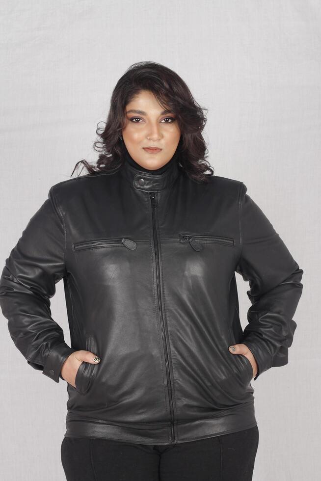 A woman in a black leather jacket and black pants photo