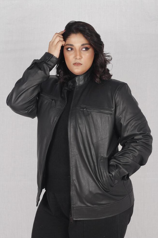 A woman in a black leather jacket and black pants photo