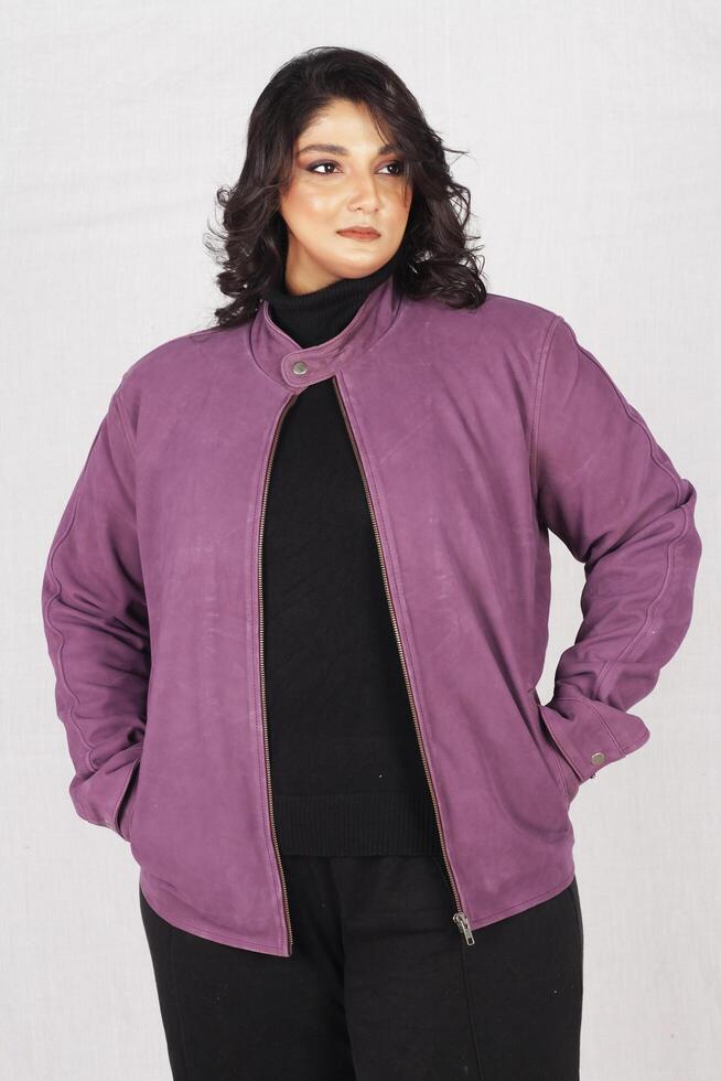 a woman in a purple jacket and black pants photo