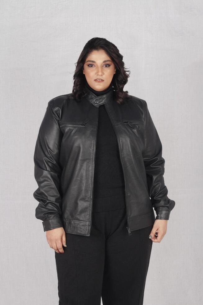 A woman in a black leather jacket and black pants photo