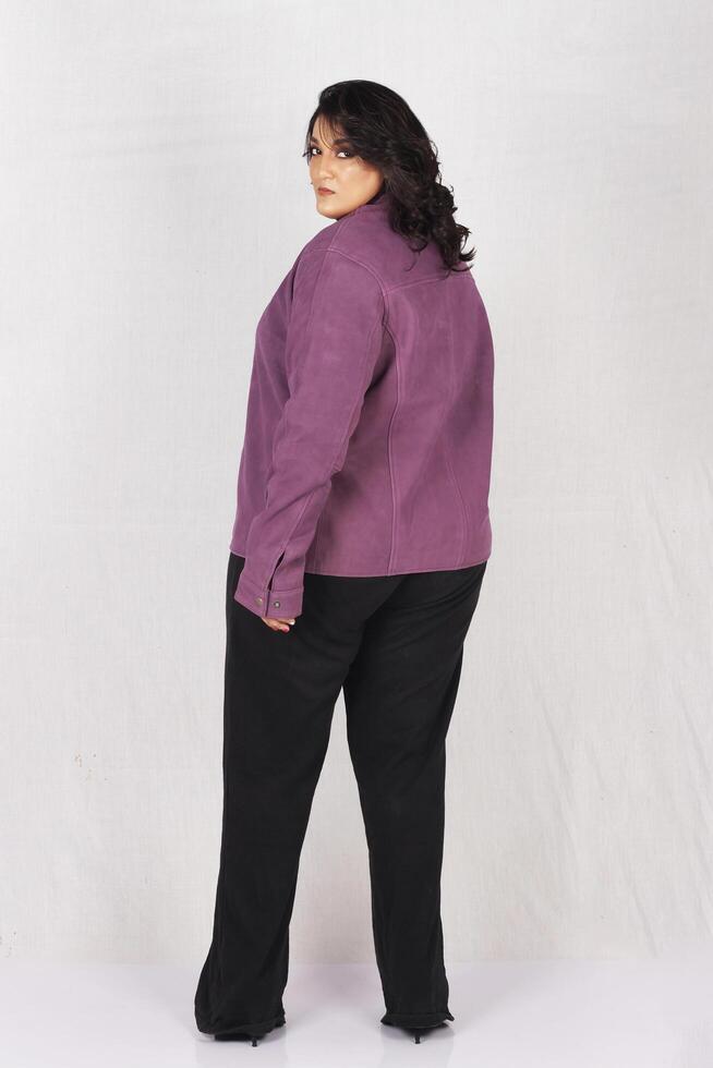 a woman in a purple jacket and black pants photo