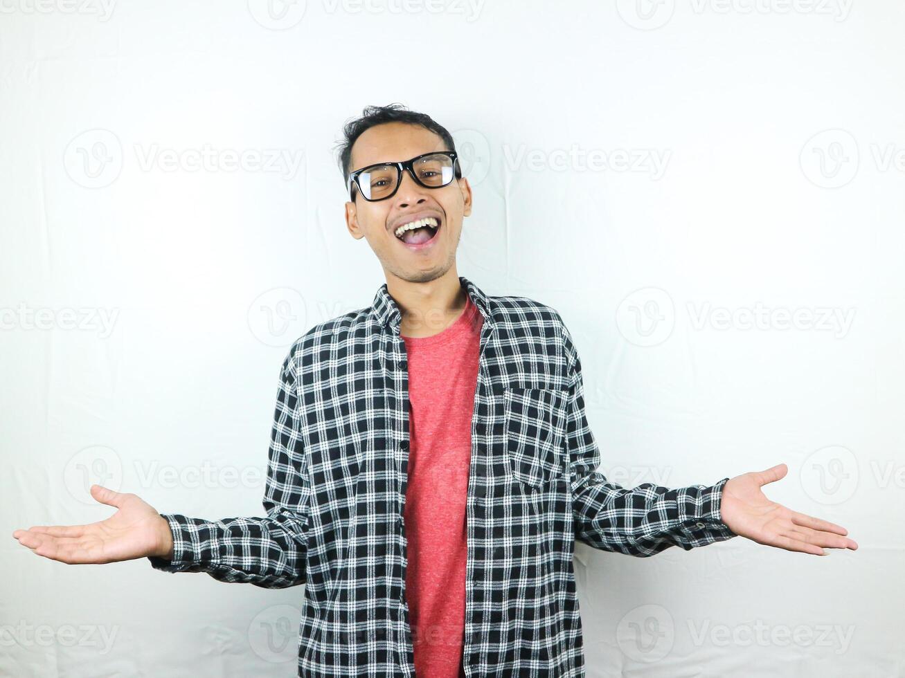Smiling asian man raising his hands with open palms gesture, isolated on white background photo