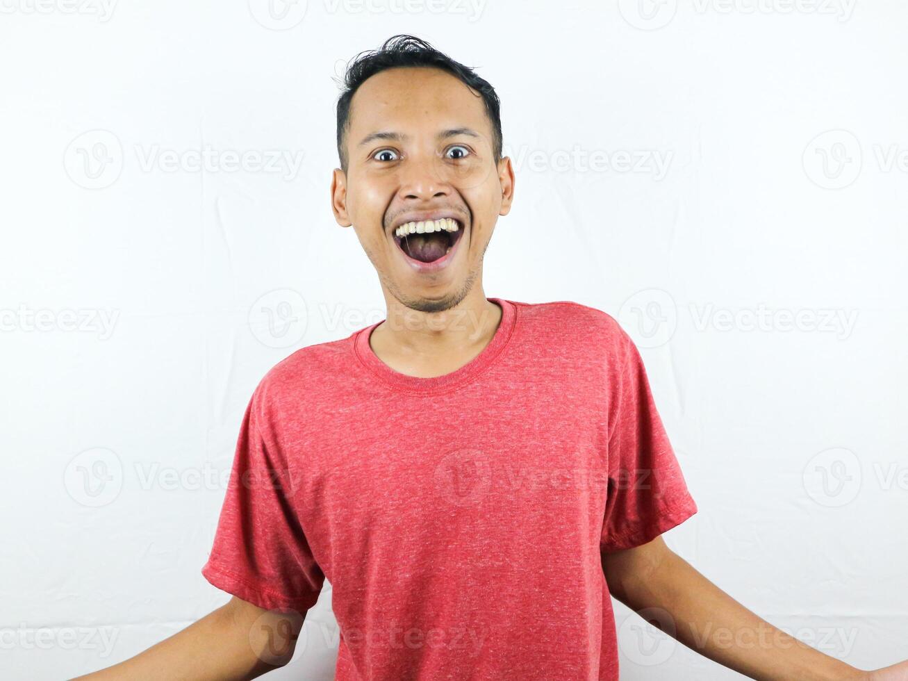 Smiling asian man raising his hands with open palms gesture, isolated on white background photo