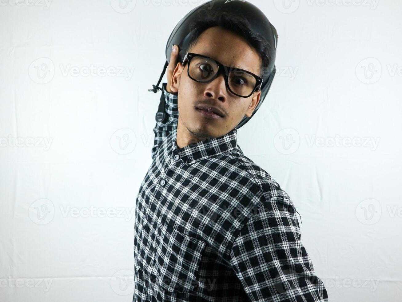 Portrait angry young man threw something at you on white isolated background, looking at camera photo