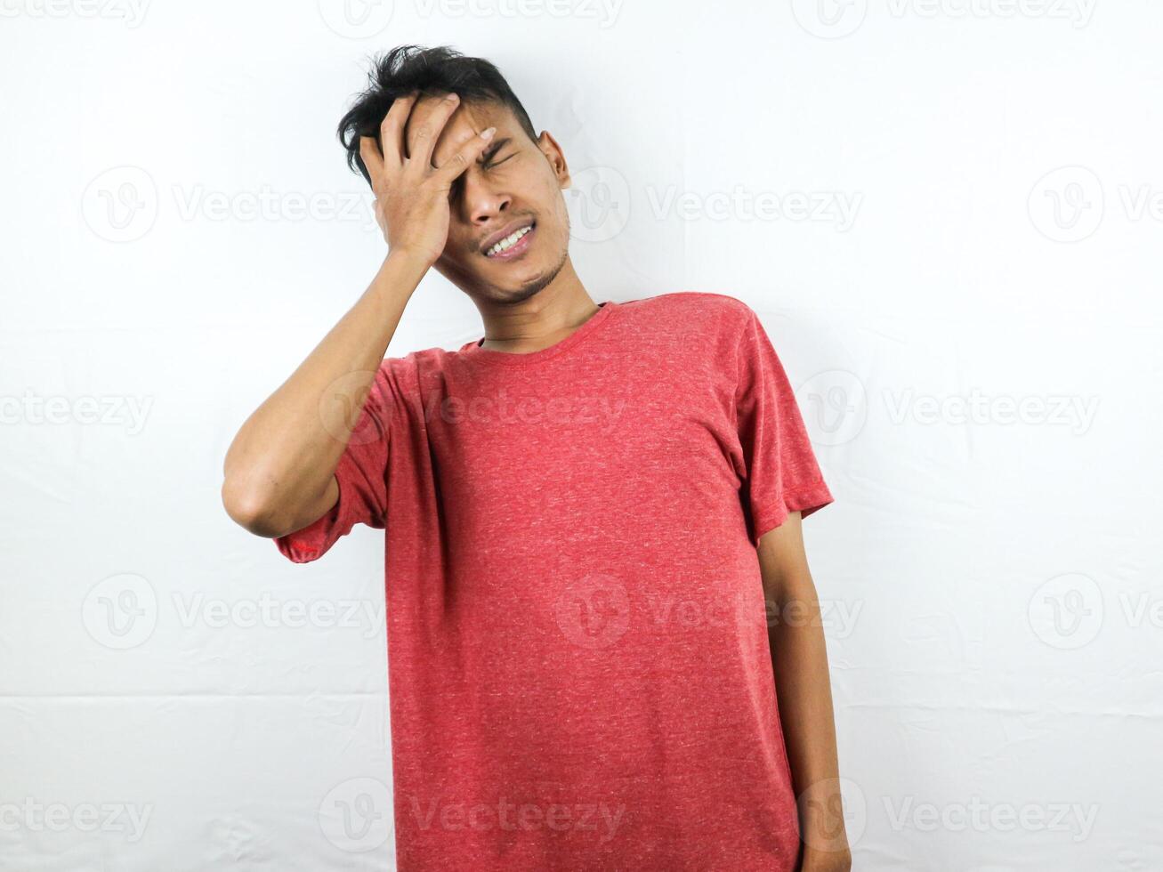 Tired asian man with yawn face expression, sleepy and back pain on white background photo