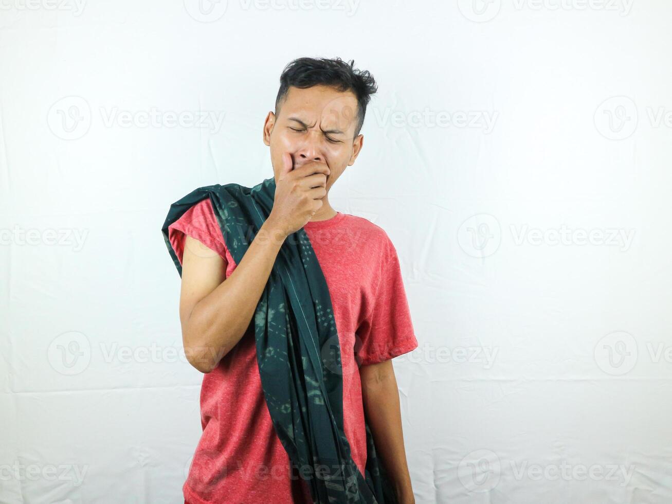 Tired asian man with yawn face expression, sleepy and back pain on white background photo