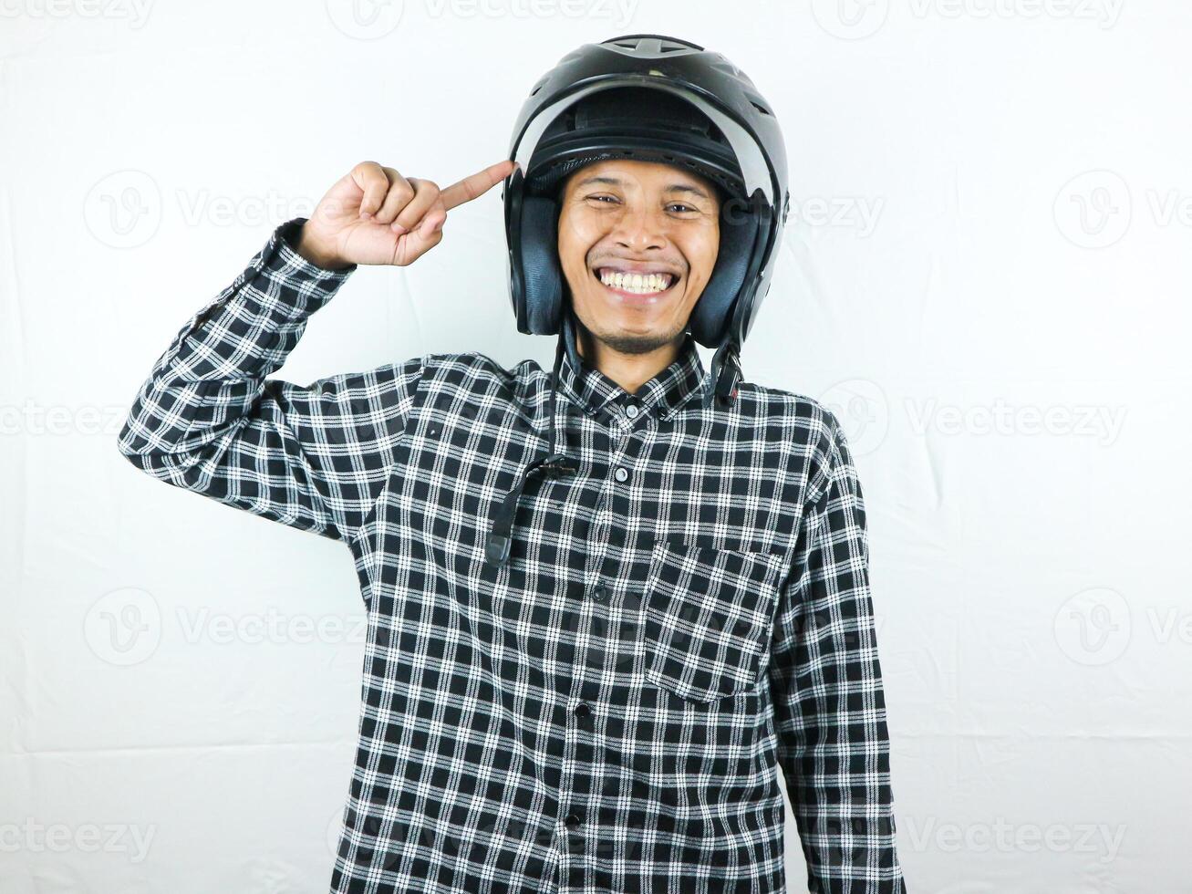 Portrait Asian man holding motorcycle helmet with excited expression. Safety riding. photo