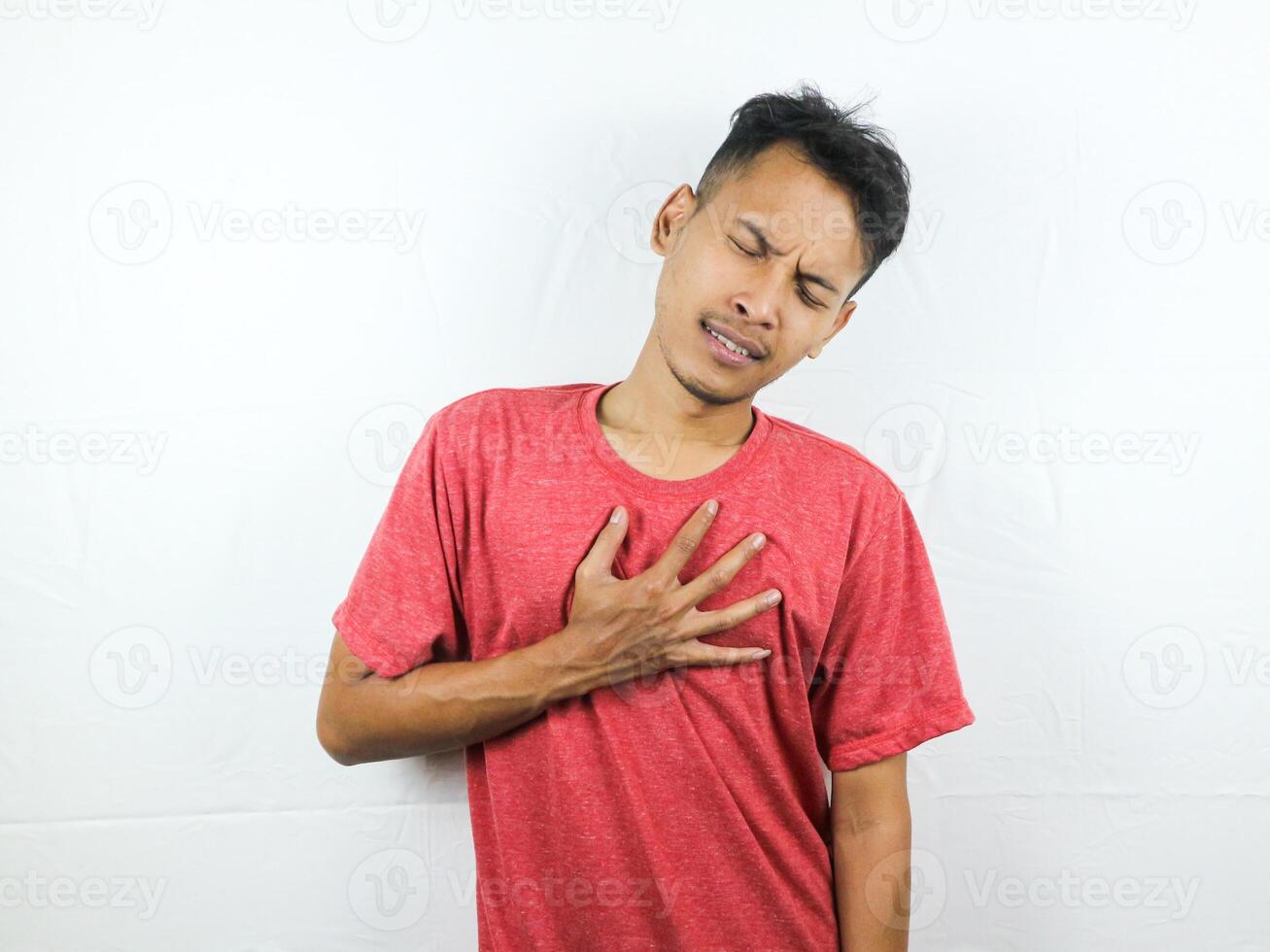 Tired asian man with yawn face expression, sleepy and back pain on white background photo
