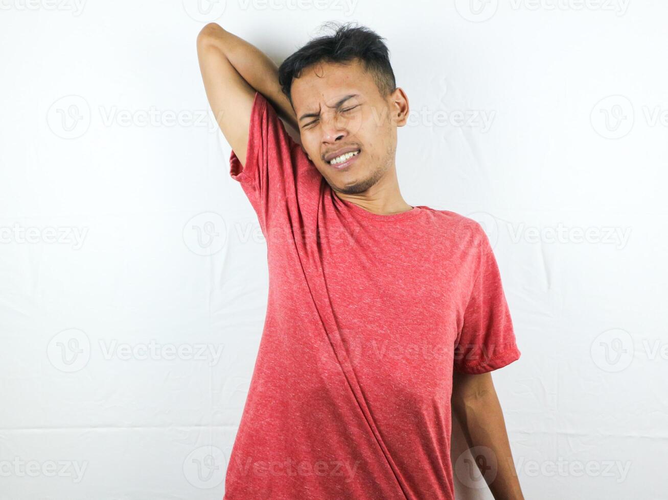Tired asian man with yawn face expression, sleepy and back pain on white background photo