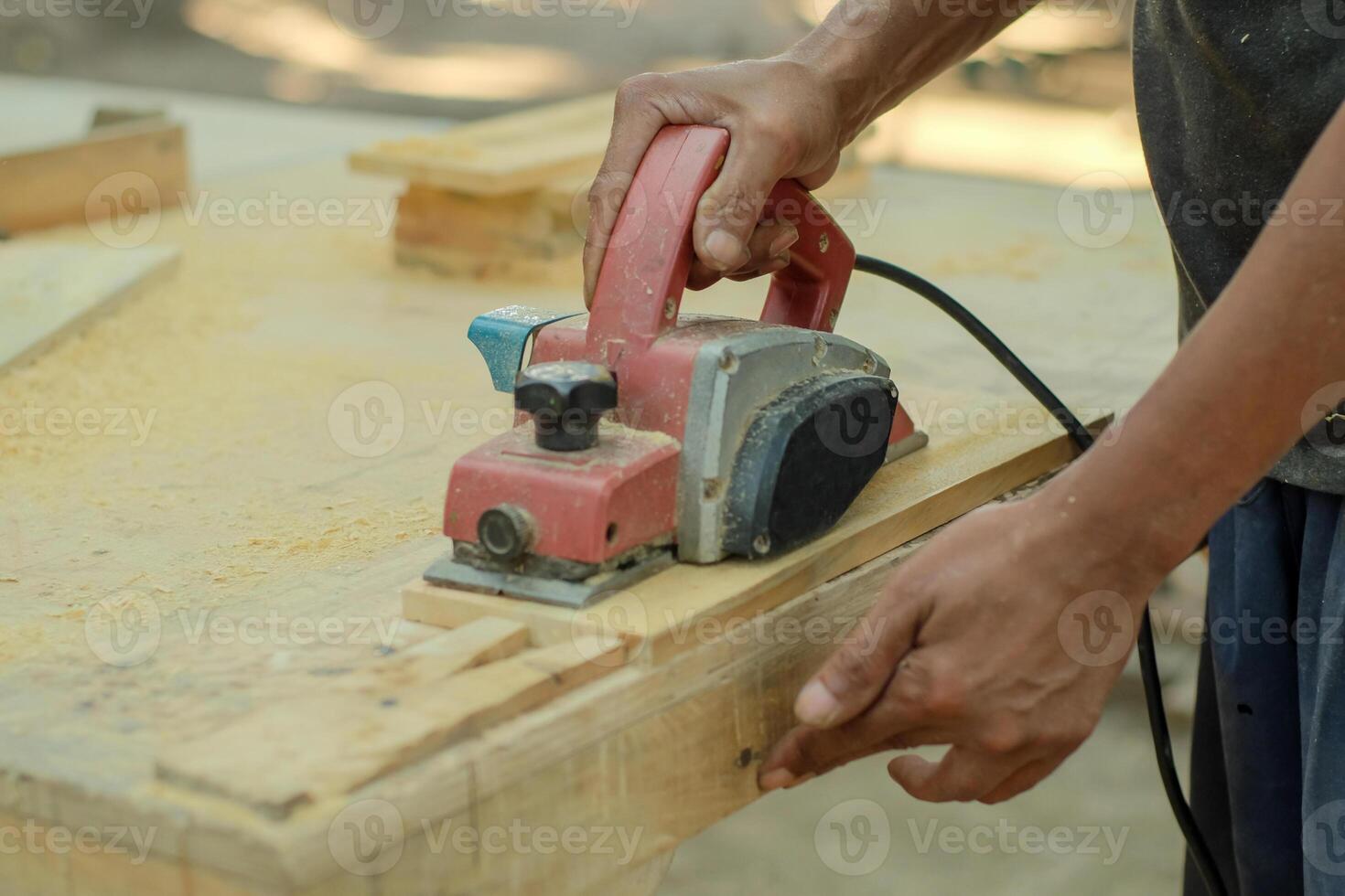 Close up of sanding a wood with orbital sander at workshop photo