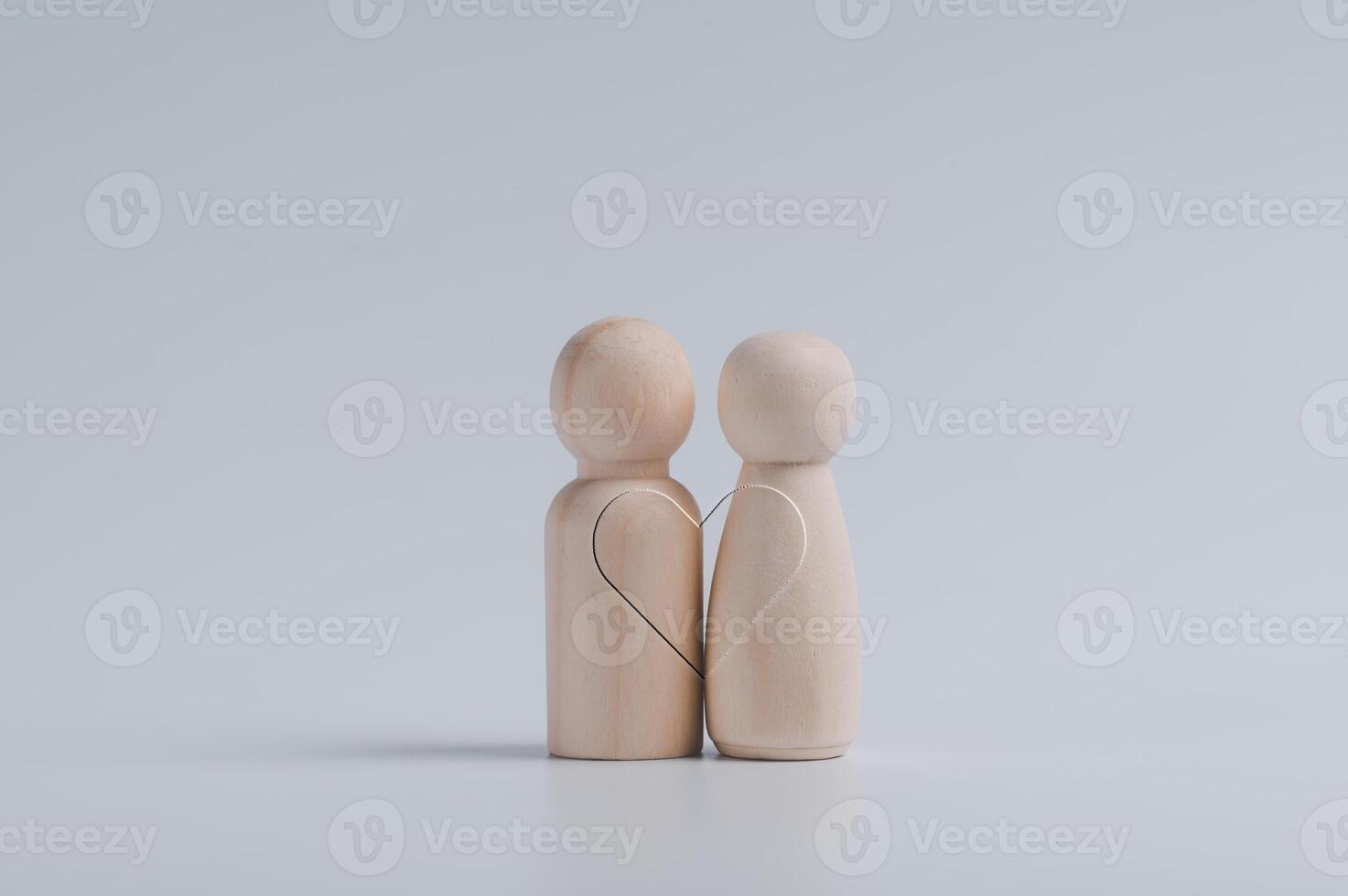 wooden peg dolls couple with line heart shape on white background. Love, romantic, relationship, Valentine's Day photo
