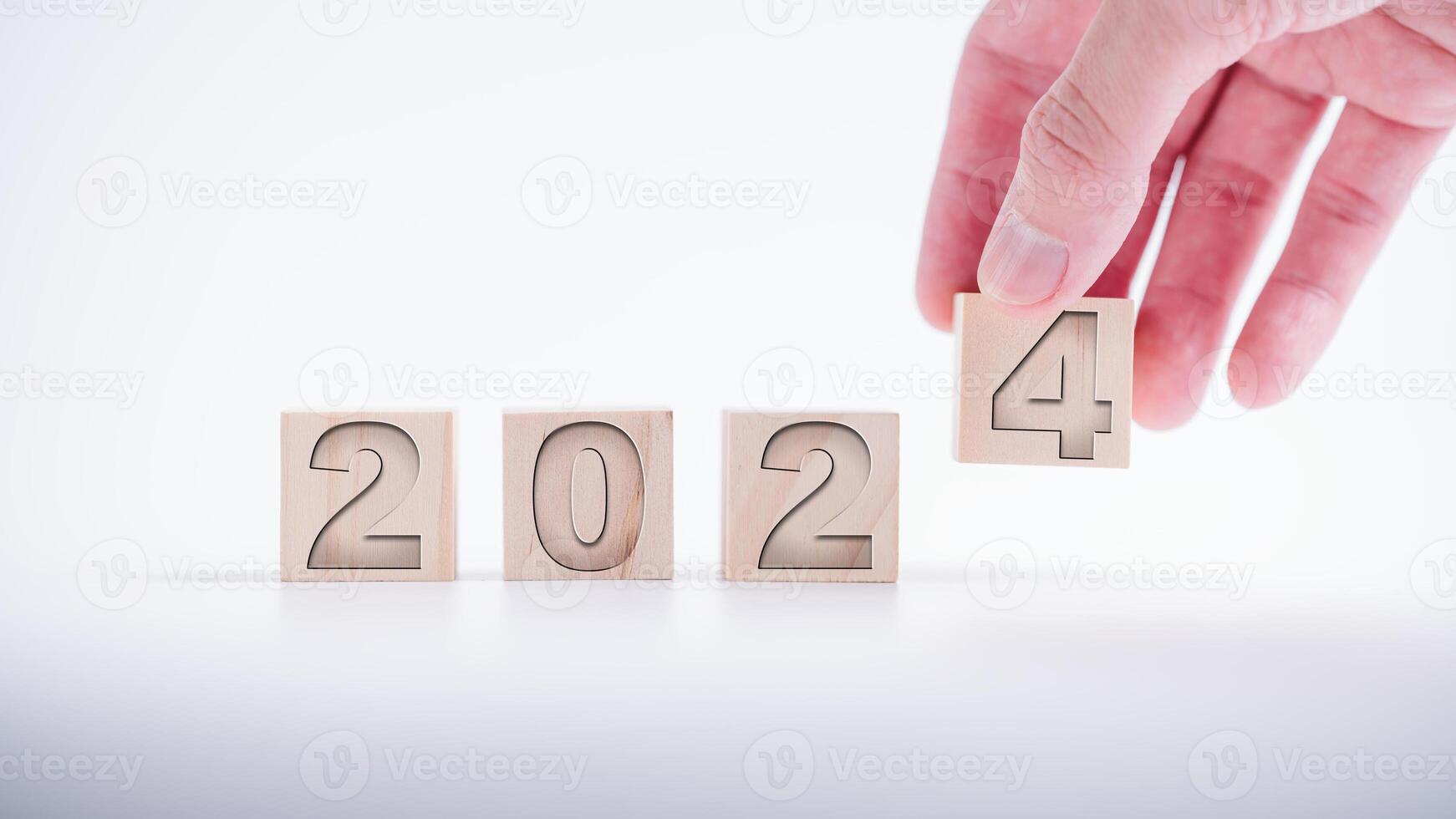 hand laying wooden cubes with the text 2024  over background. new business goal strategy concept.2024 goal planning business concept photo