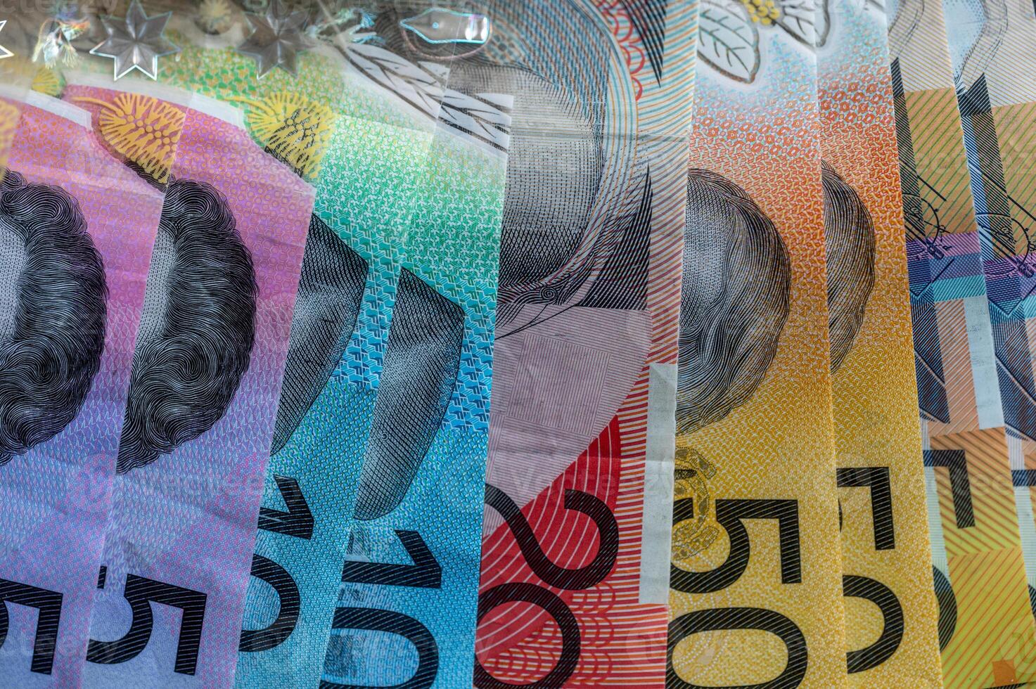 Finance and saving Australian dollar notes as background. Color AUD banknotes. photo