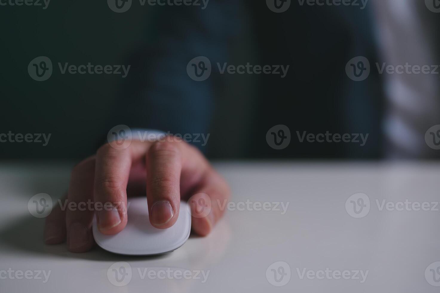 Close up of hand using on white mouse and clicking on office table photo