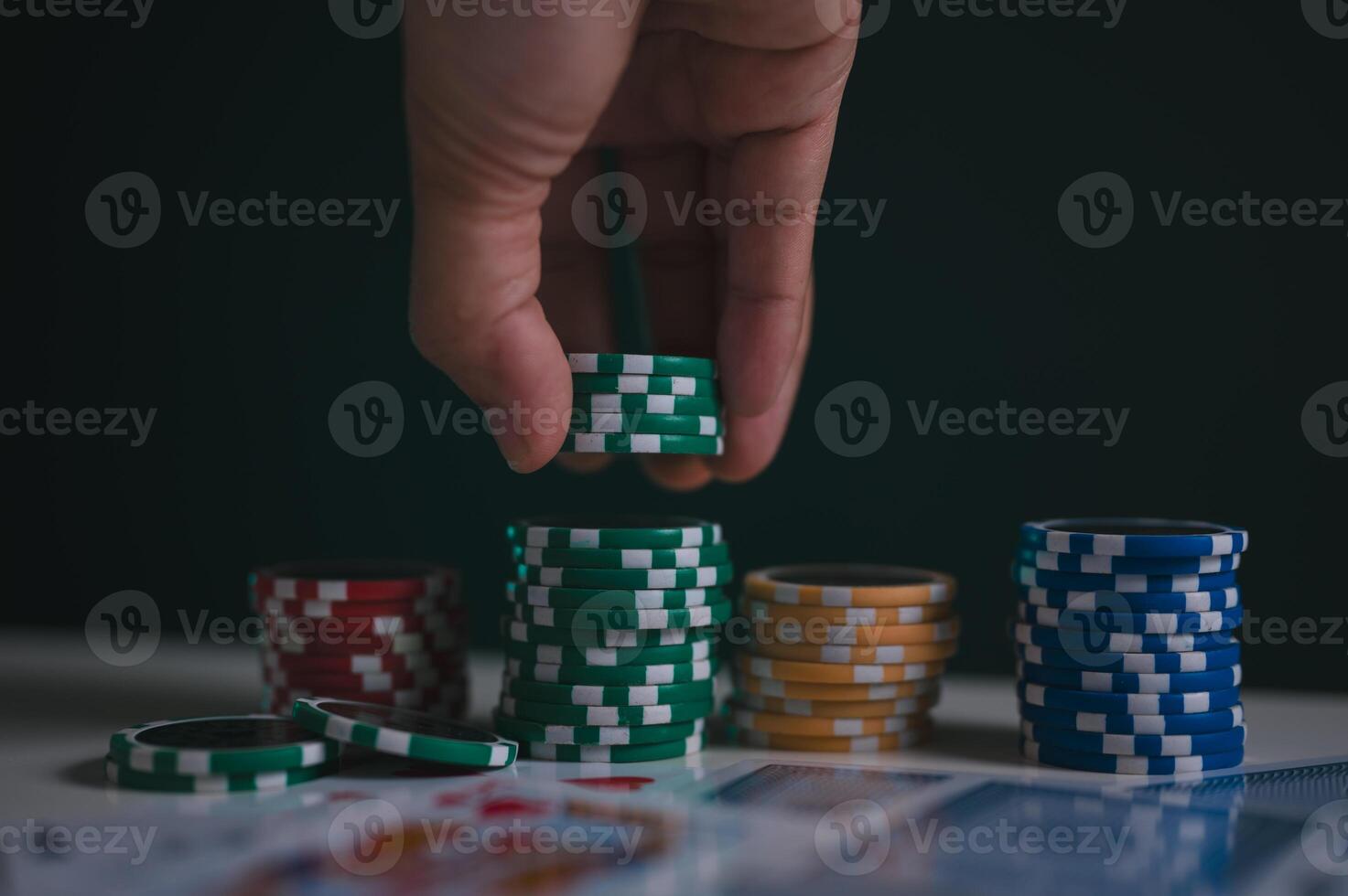 a man or poker player stack chips on table in concept of casino gambling all in photo