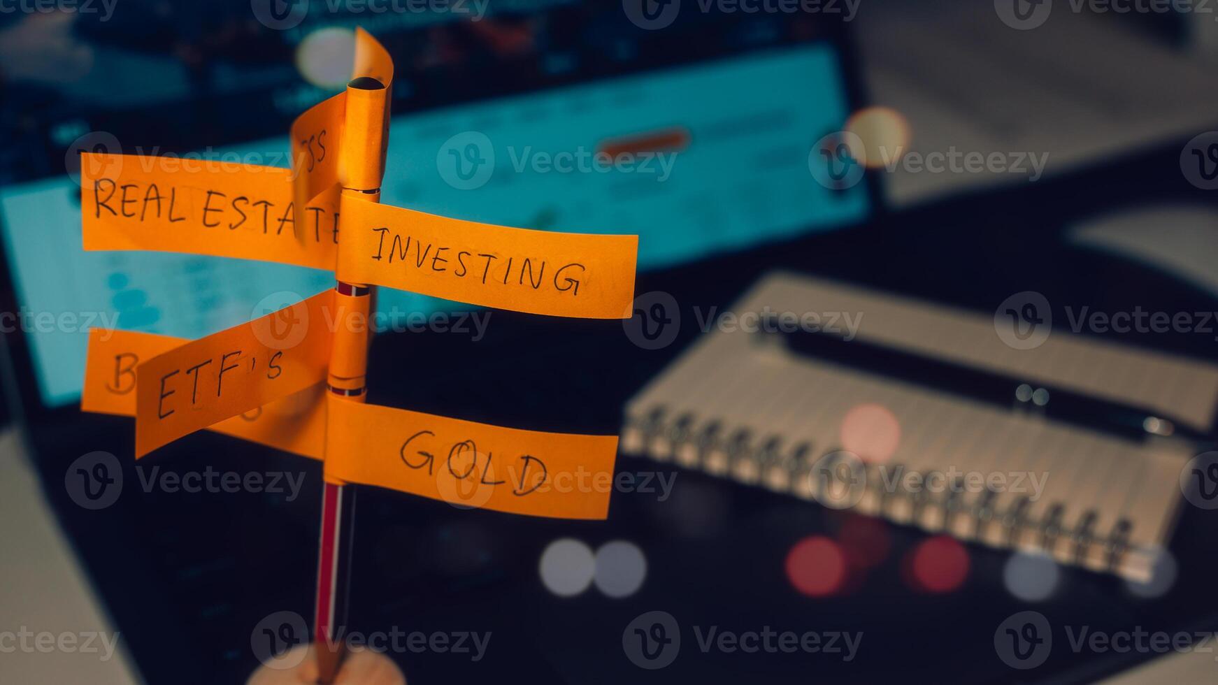 Financial Investments and asset allocation concept. direction sign with investment options on blurred office computer background photo