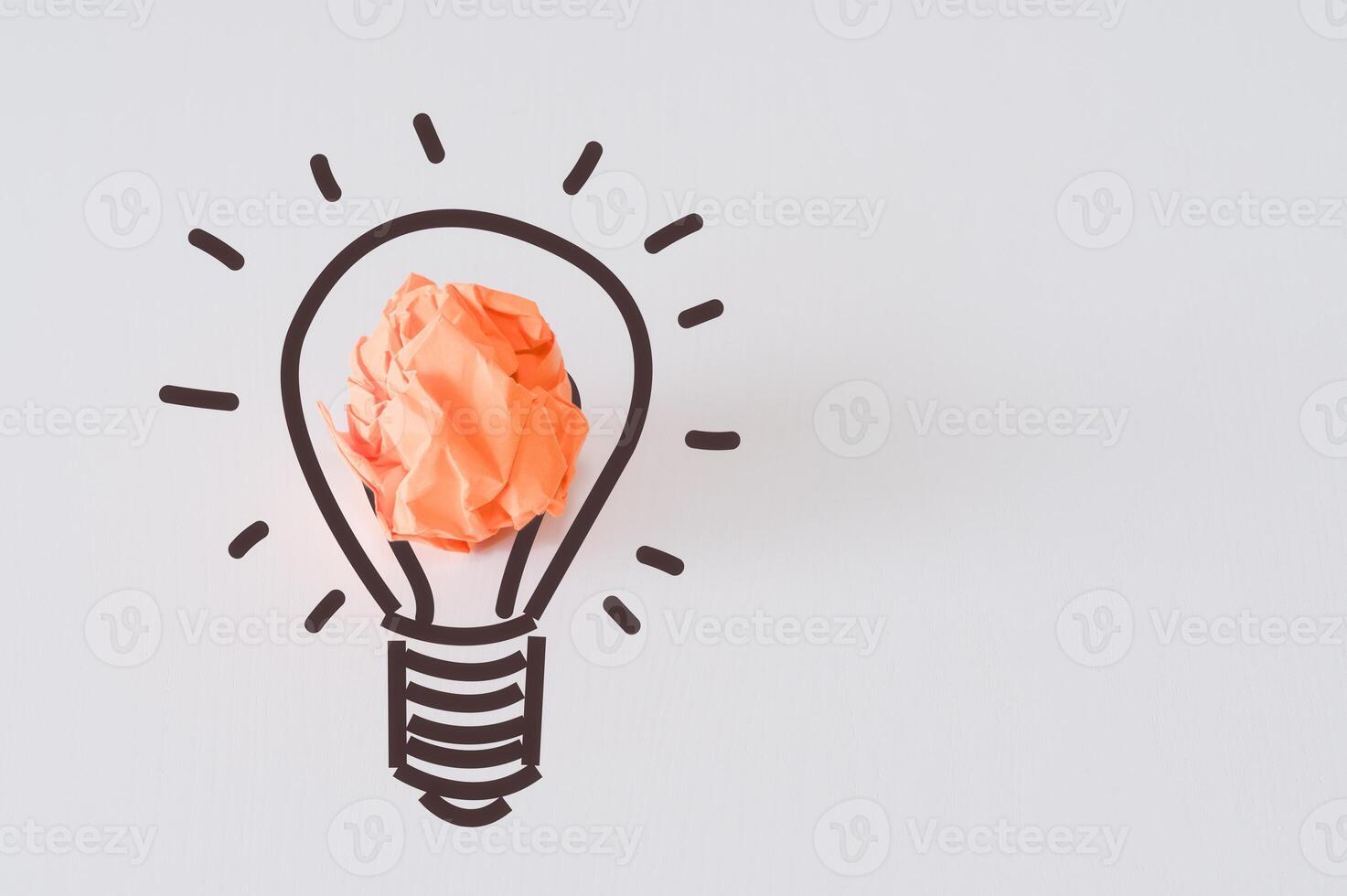 New ideas and Creative thinking innovation concept. Paper scrap ball orange colour with light bulb symbol on white background photo