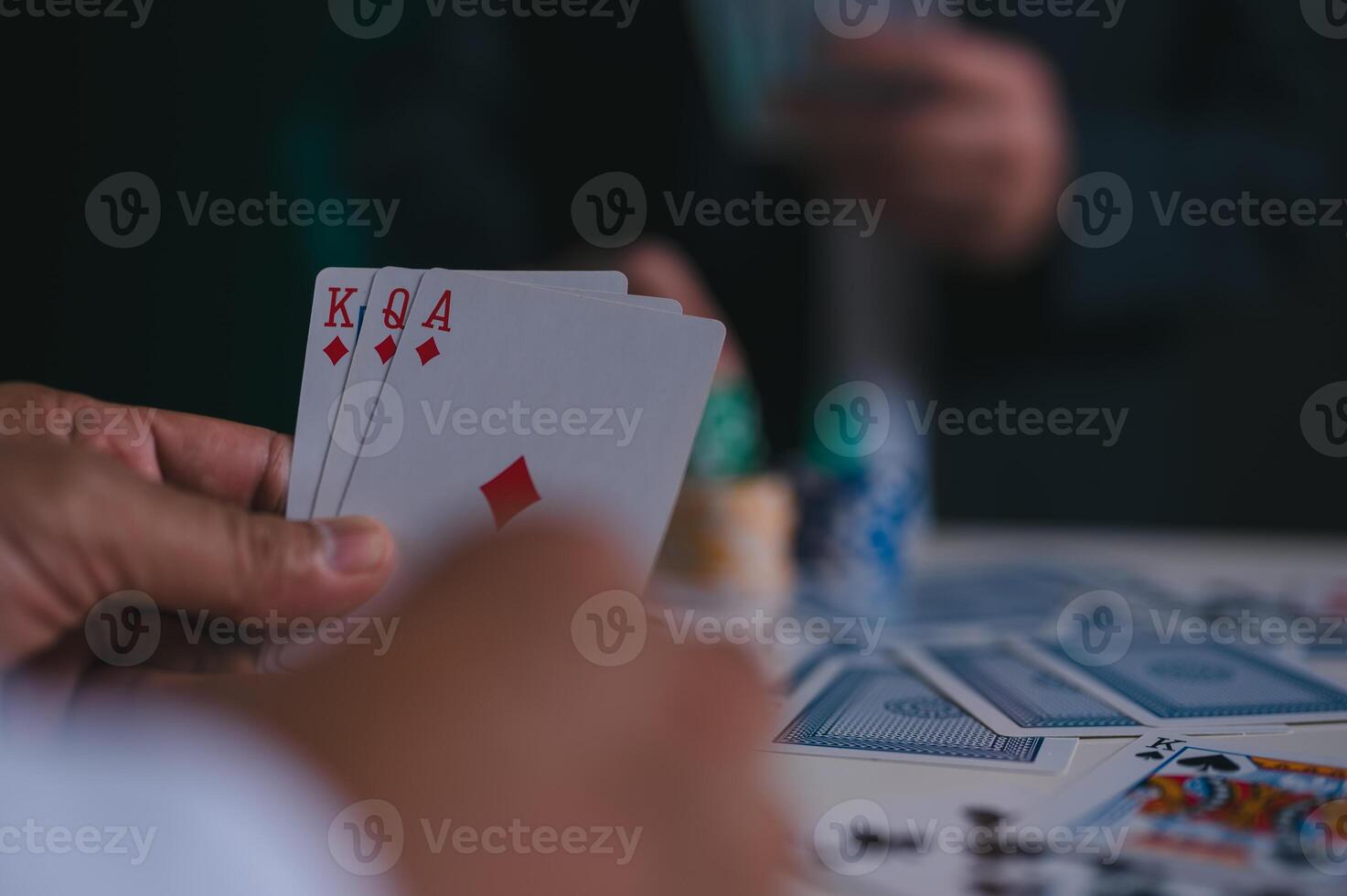 hand holding cards, poker chips casino background in concept of gambling all in photo