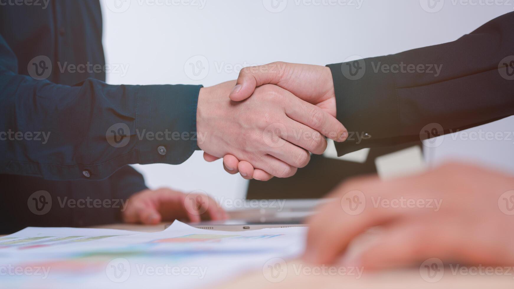 Hand shake concept, businessman is shaking their hands together for greeting dealing business join venture or investment in successful business photo