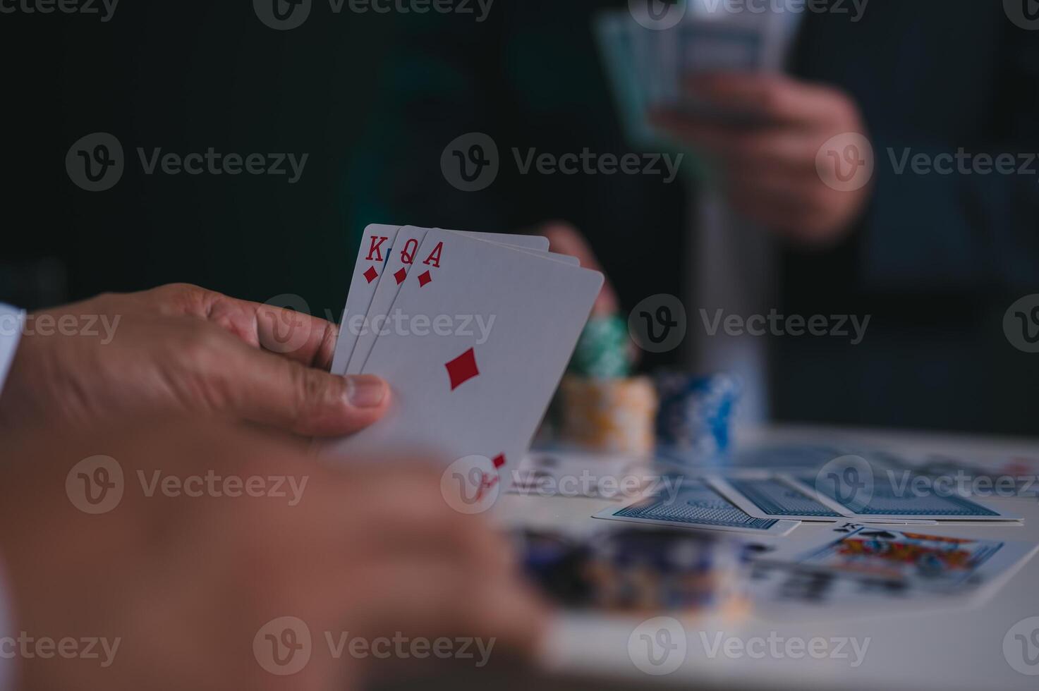 hand holding cards, poker chips casino background in concept of gambling all in photo