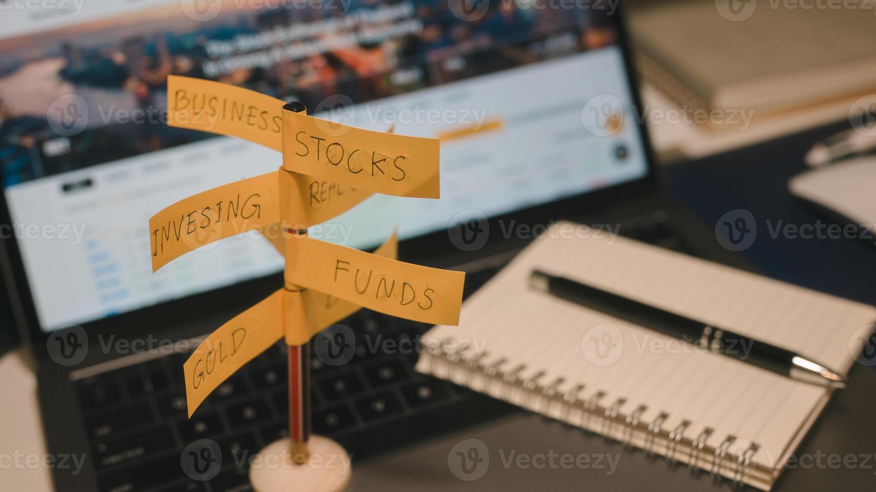 Financial Investments and asset allocation concept. direction sign with investment options on blurred office computer background photo