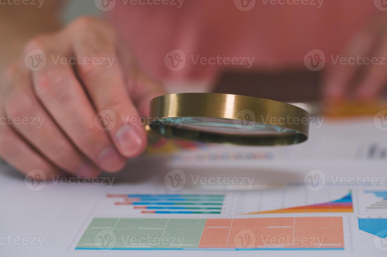 man using magnifying glass on graph paper in financial development Banking Account Statistics Investment Analytic research data economy Business concept photo