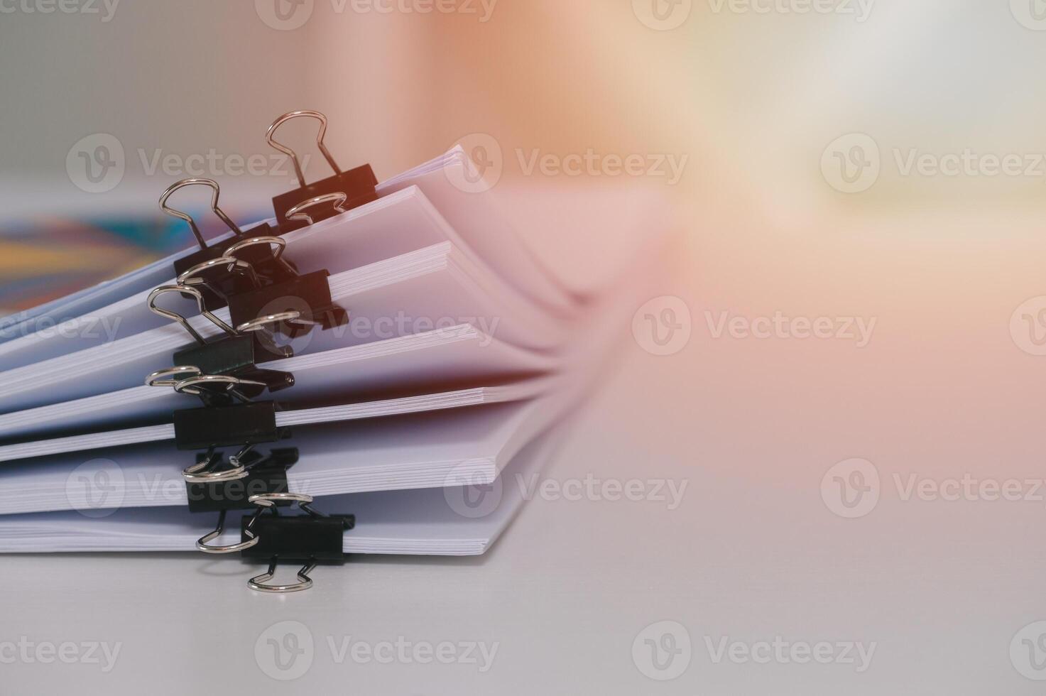 pile of unfinished documents on office desk, Stack of business paper home office business report with clips indoor photo