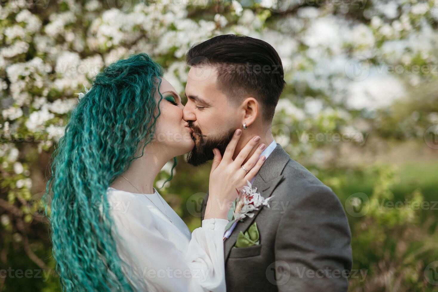 a bearded groom and a girl with green hair are walking photo