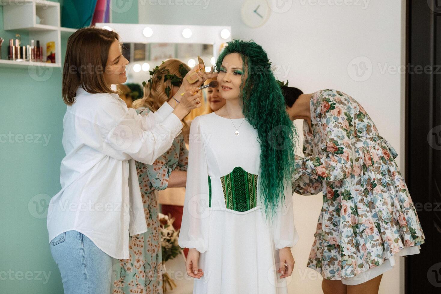 portrait of a bride with green curly hair in the beauty room photo