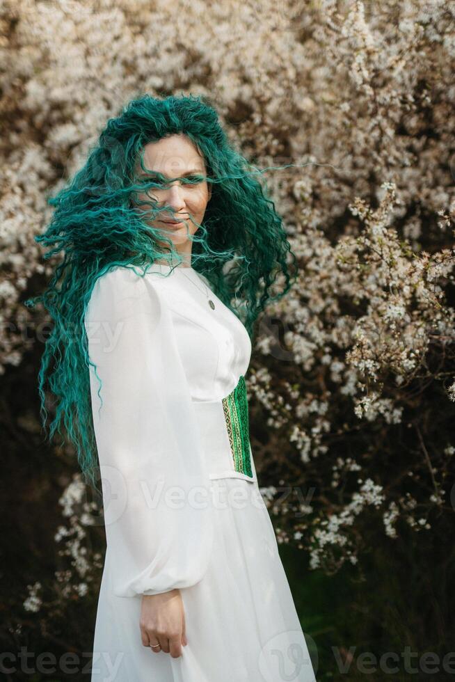 young girl bride with green hair in a national dress photo