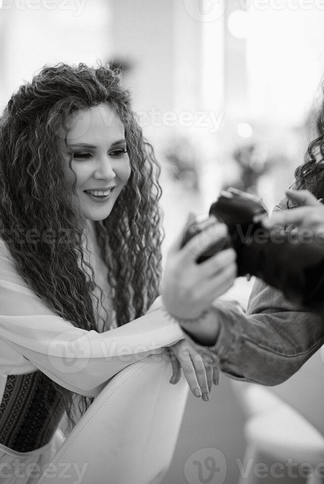 portrait of a bride with green curly hair in the beauty room photo