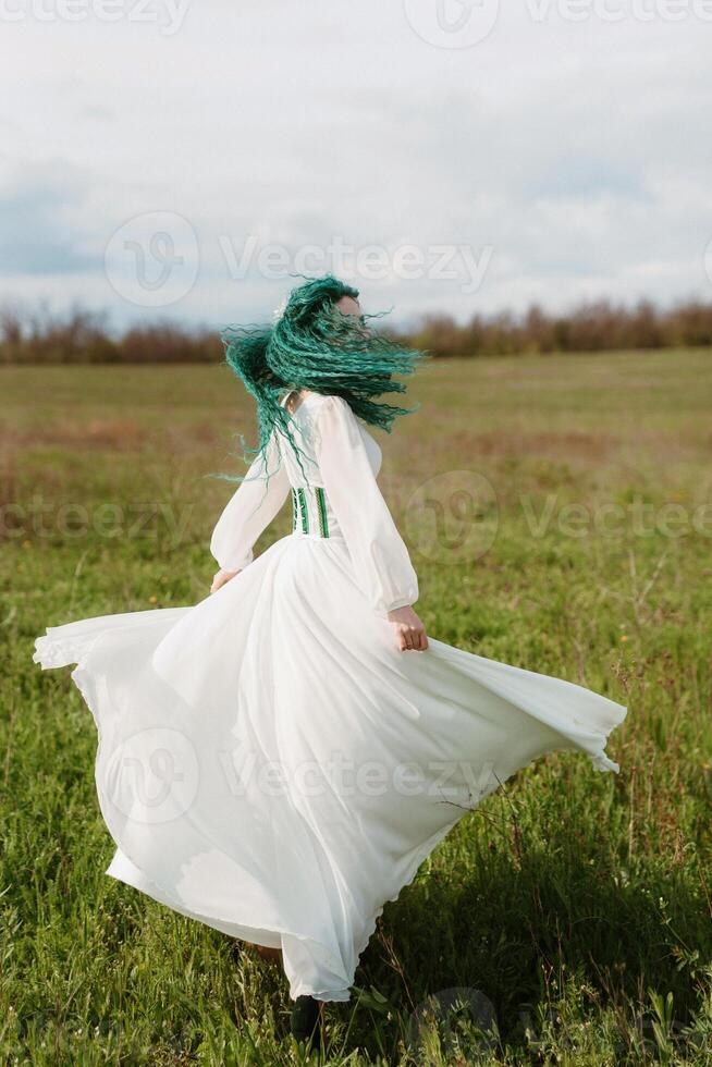 young girl bride with green hair in a national dress photo