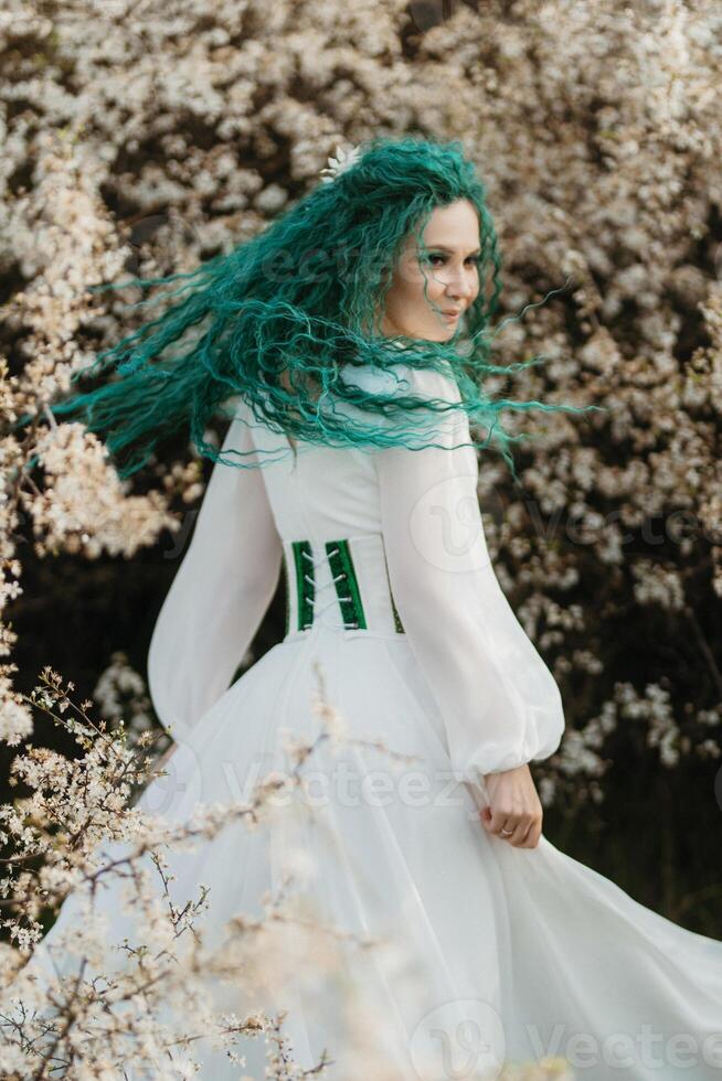 young girl bride with green hair in a national dress photo