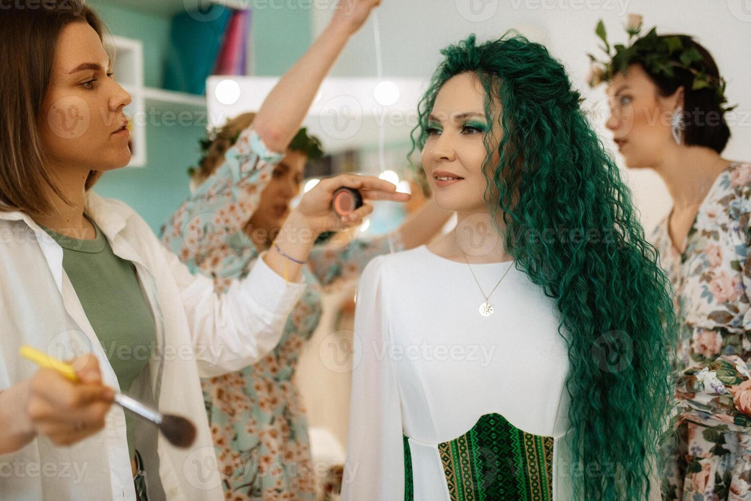 portrait of a bride with green curly hair in the beauty room photo