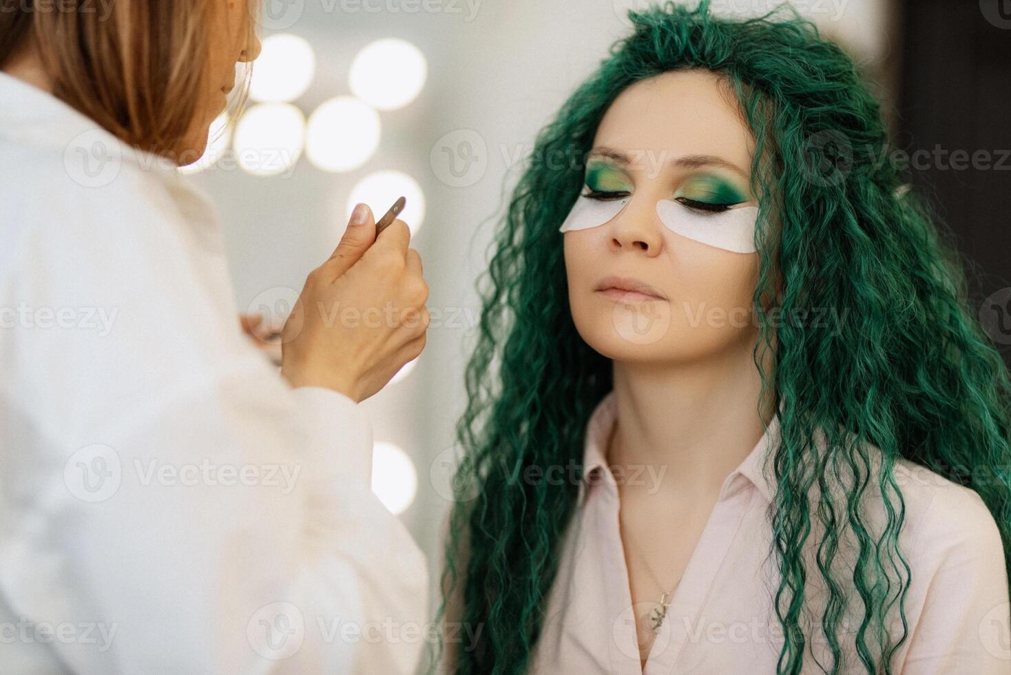 portrait of a bride with green curly hair in the beauty room photo