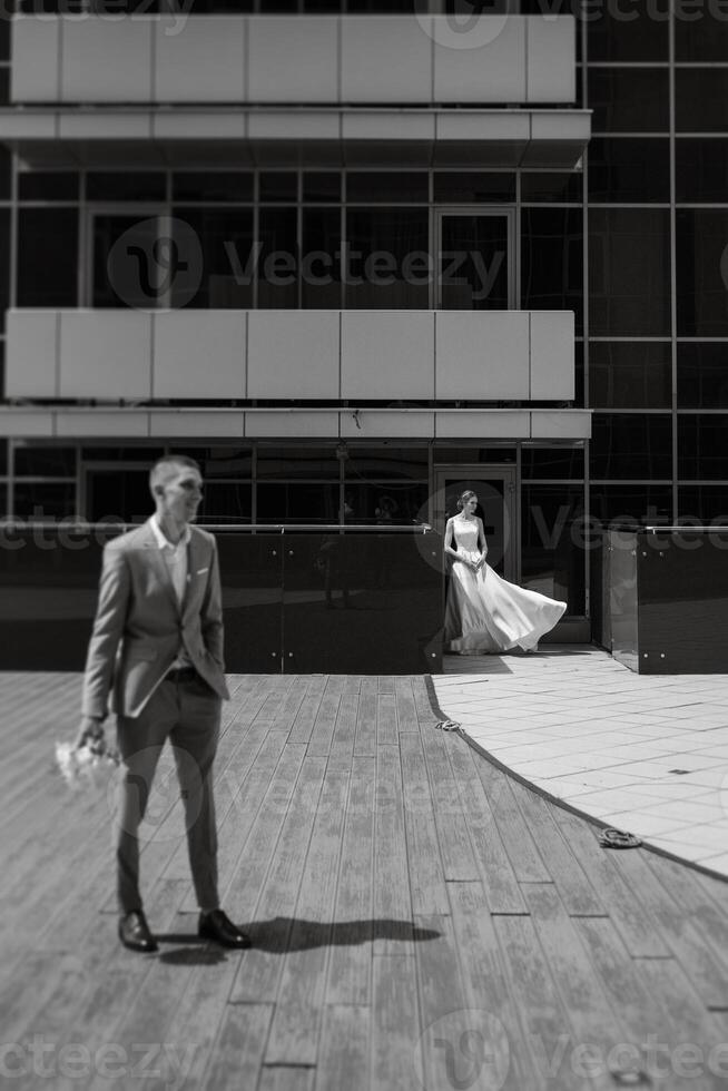 bride and groom first meeting on the roof of skyscraper photo