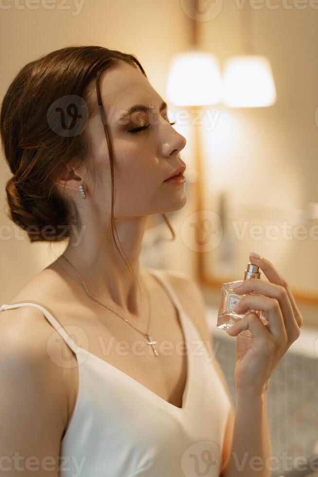 bride in a veil with makeup paints her lips photo