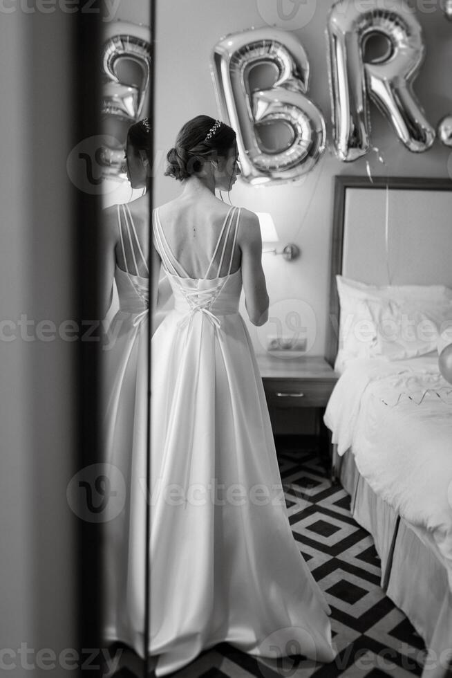 preparations for the bride with the dressing of the wedding dress photo