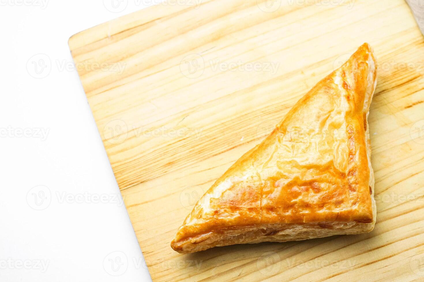 Chicken Pie or Baklava on wooden board and wood spoon on white background photo