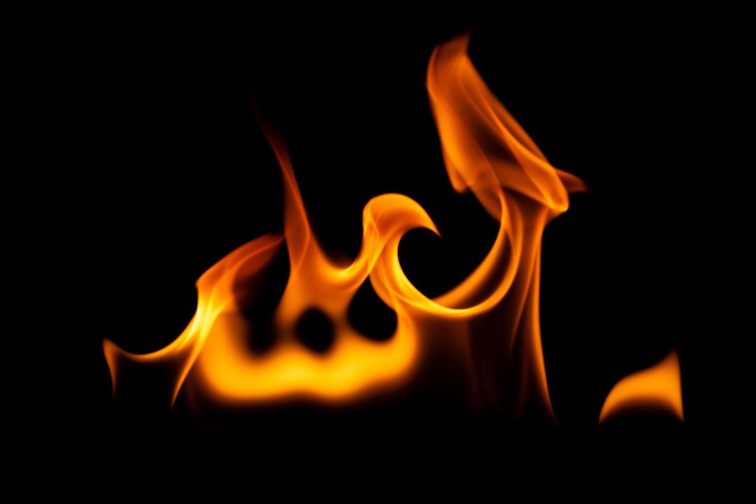 Hot flames on a black background. Beautiful flame of fire in the dark. Abstract of burning flames and smoke. photo