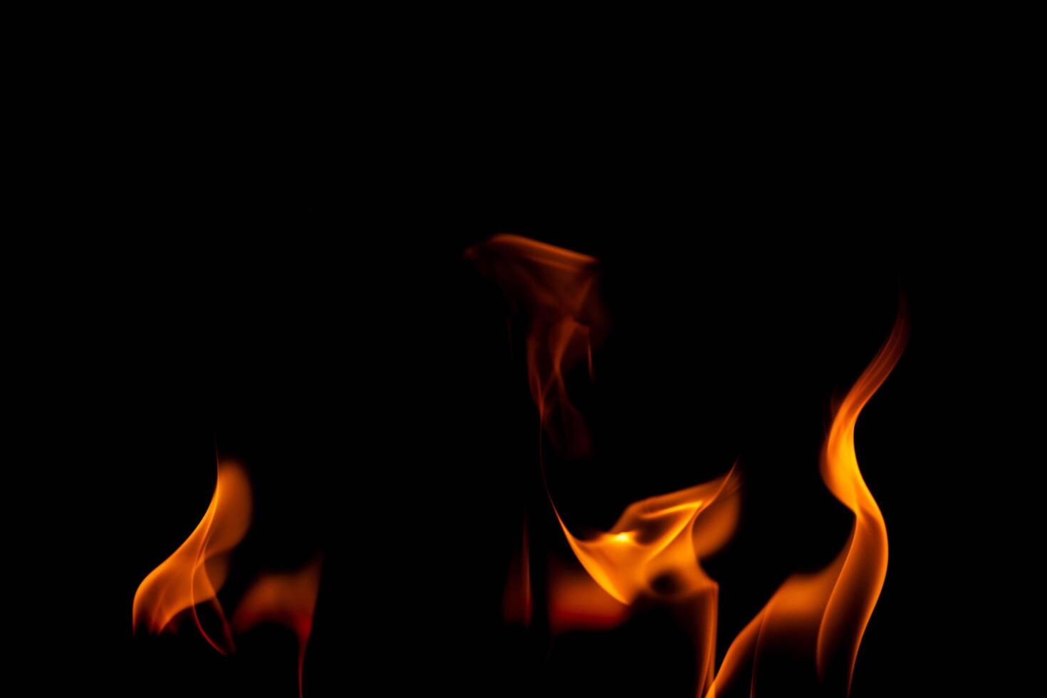 Hot flames on a black background. Beautiful flame of fire in the dark. Abstract of burning flames and smoke. photo