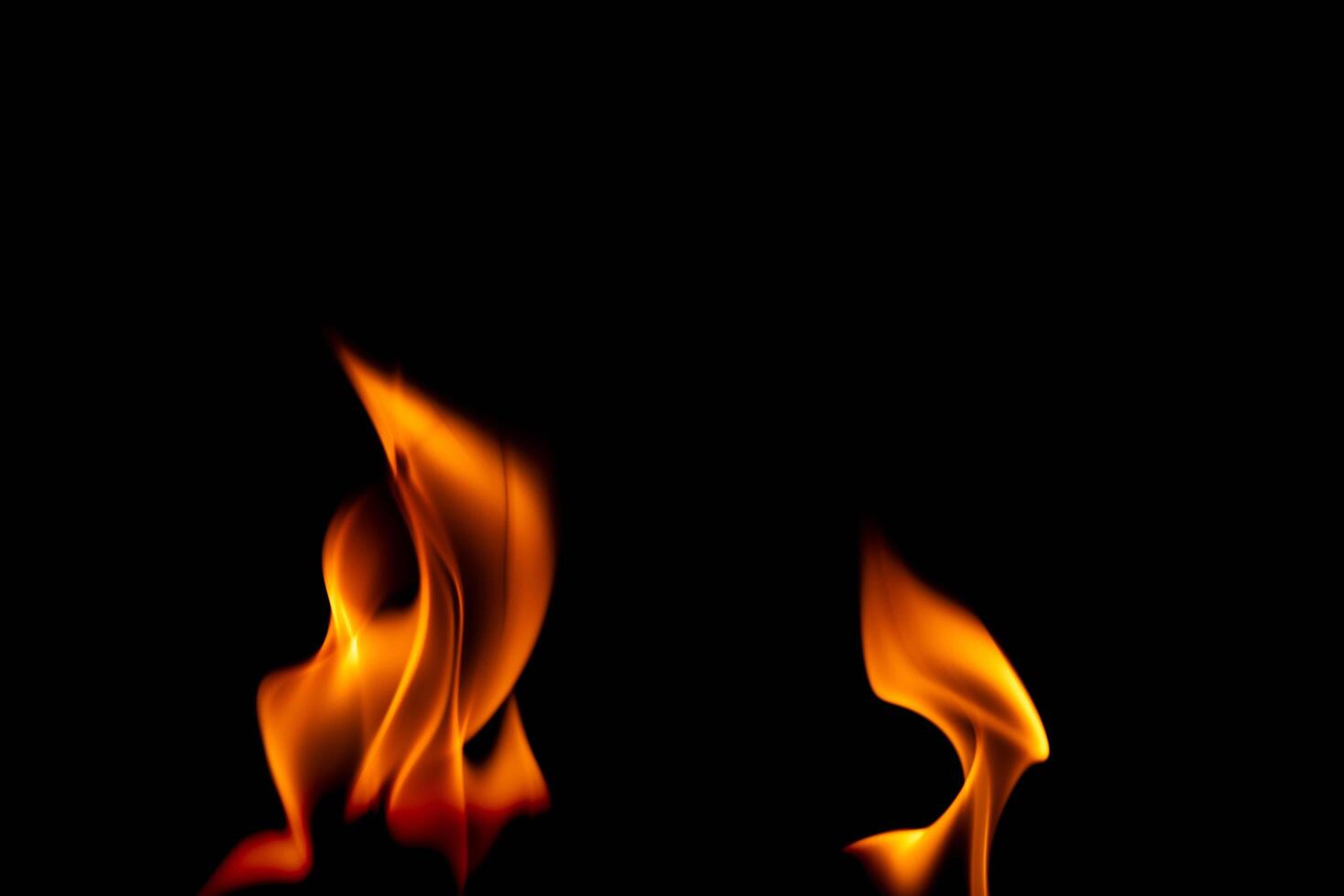 Hot flames on a black background. Beautiful flame of fire in the dark. Abstract of burning flames and smoke. photo