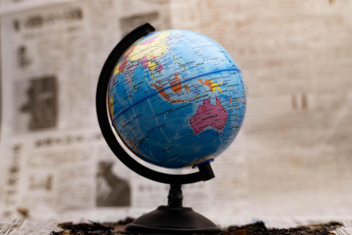 Model globe on a newspaper in the background. photo