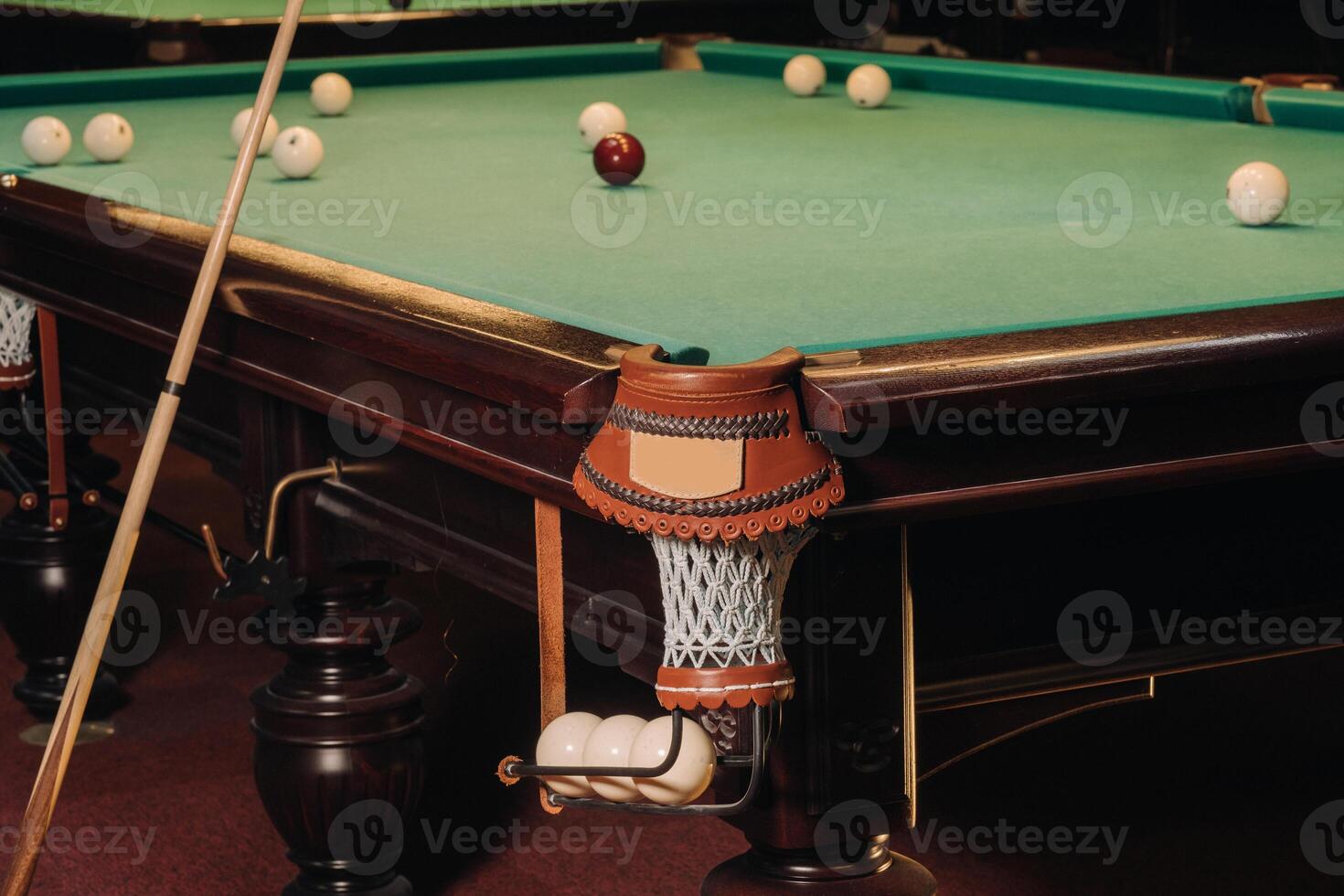 A pool table with balls that have already been played in the pool club.Playing billiards photo