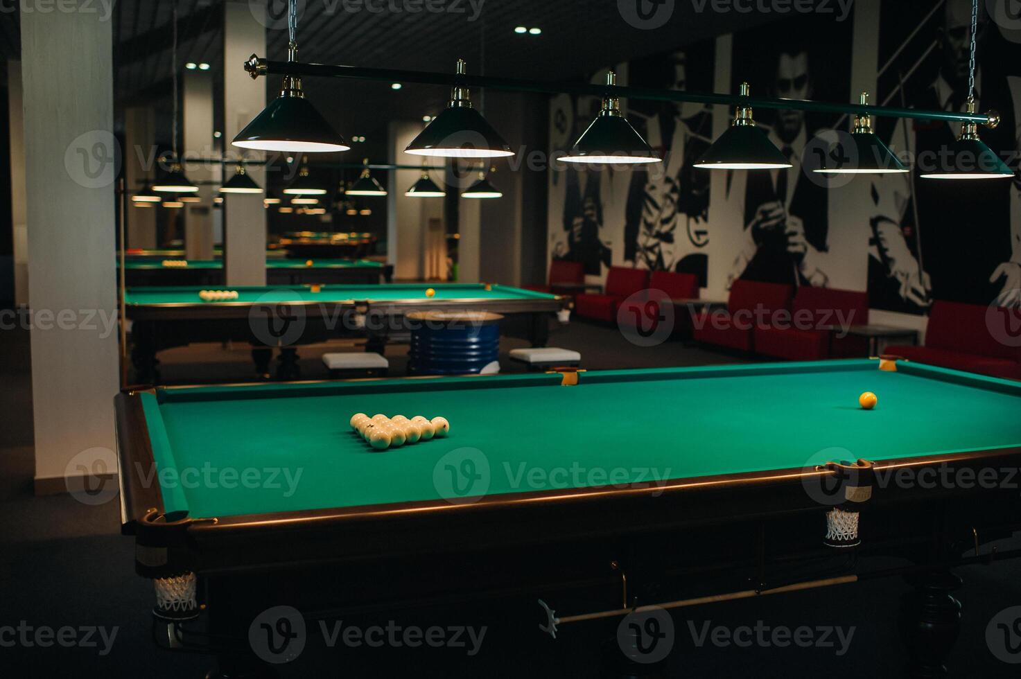 there are a lot of billiard tables with green surfaces and balls in the billiard club photo
