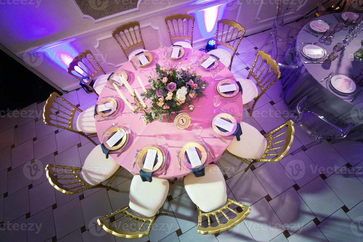 decoration of the festive dinner with flowers of lilies and tulips on the wedding table in the interior of the restaurant. Decorated table for celebration photo